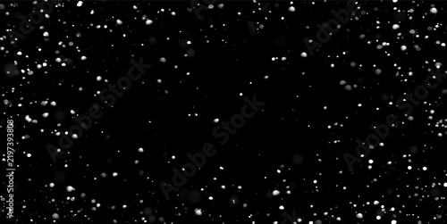 Foto Floating white particles are scattered across a deep black background