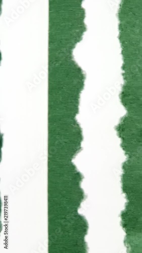 Hanging torn green paper with subtle variations in textures and shapes over time