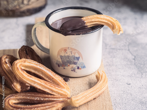 Traditional Spanish churros dipped in hot chocolate