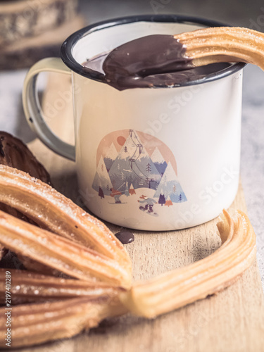 Traditional Spanish churros dipped in hot chocolate