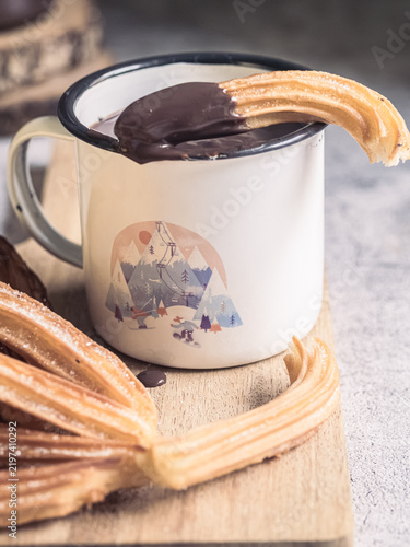 Traditional Spanish churros dipped in hot chocolate