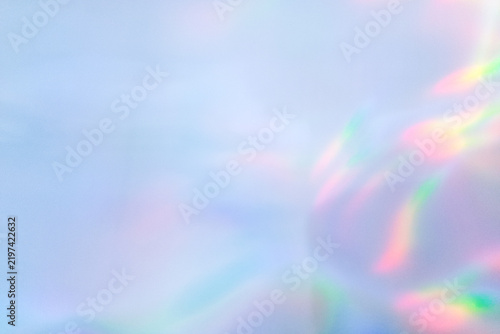 Abstract pastel blue background with soft holographic gradient and prismatic light leak. Aesthetic minimal overlay texture for banner and modern design.