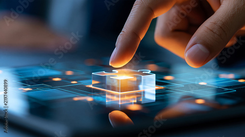 Human hand placing a luminous puzzle piece into a transparent digital grid, strategic problem solving, innovation, business growth, creative thinking, technology consulting,