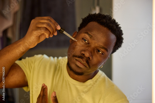 Man applies lotion to his face
