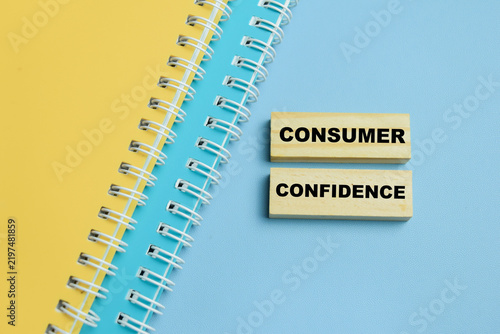 Concept of consumer confidence text on wooden blocks. For economy and retail market sentiment
