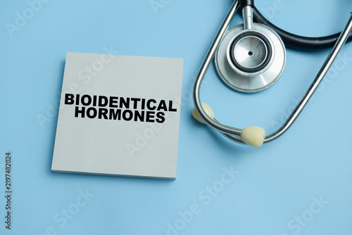 Concept of bioidentical hormones write on sticky notes isolated on table.