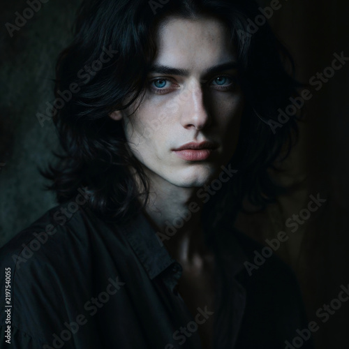 Dramatic Portrait of Young Aristocratic Man with Dark Wavy Hair and Piercing Blue Eyes