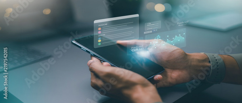 User interacting with futuristic mobile data analytics hologram