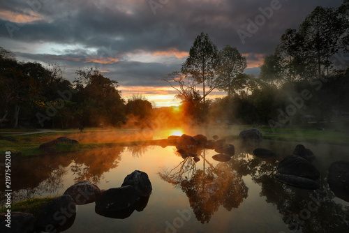 Morning fog on hot spring with the environment and tropical rainforest