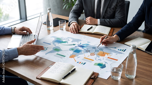 Business colleagues analyzing a global map during a boardroom meeting