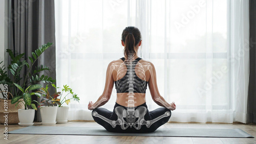 Young woman practicing meditation in a bright indoor space with natural light