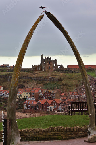 Old real whalebone arch at Whitby, North Yorkshire; historic whaling heritage archway framing Whitby Abbey ruins and St Mary's Church, iconic coastal viewpoint on Yorkshire Coast, England, UK