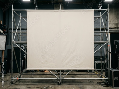 Large fabric banner draped across metal scaffolding structure