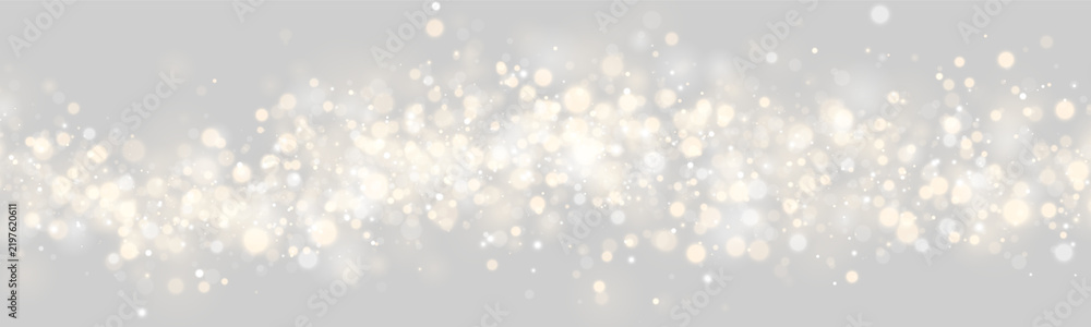 Obraz premium A dense cluster of glowing bokeh lights creates a sparkling effect. The lights are circular and soft, blending warm gold and cool silver tones. This luminous pattern enhances festive and.