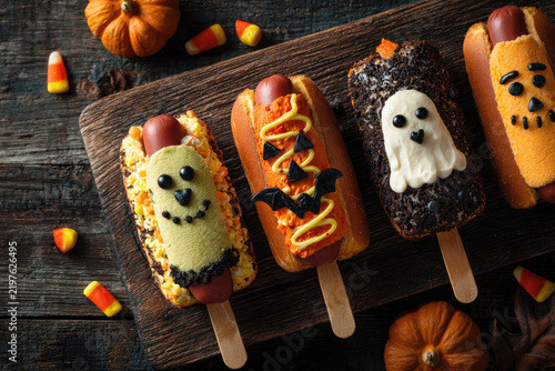 Halloween food. Halloween cake. Halloween homemade cakes. Autumn theme. Homemade dessert idea.Halloween hot dog.Dark wooden background.