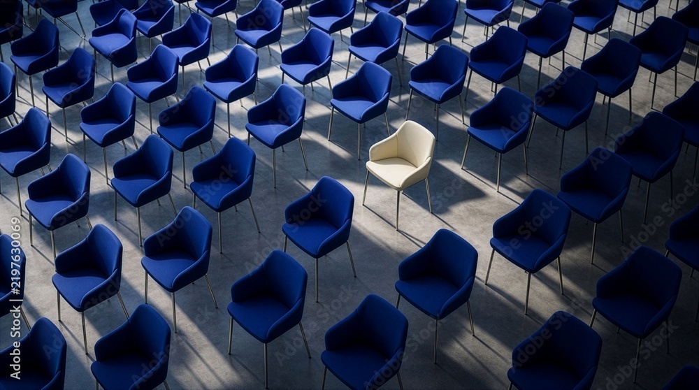 Fototapeta premium White chair standing out among rows of blue chairs