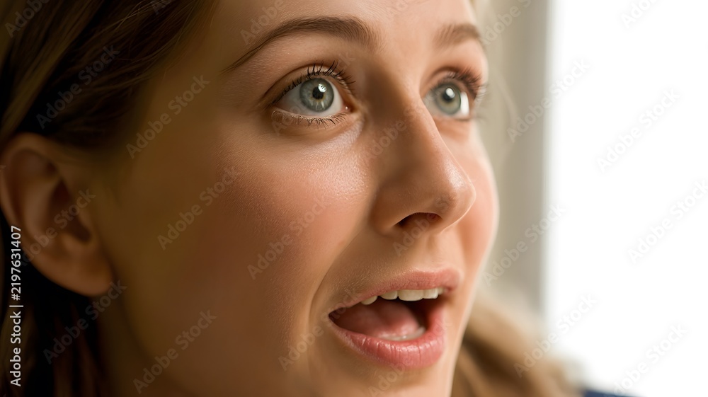 Fototapeta premium Surprised person with wide eyes and an open mouth showing astonishment in a revealing portrait capturing an unexpected reaction and a sense of wonder through facial expression and human communication.