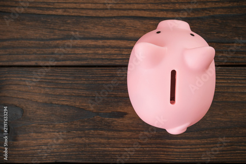 Piggy Bank on Wooden Surface: Saving and Financial Planning Concept