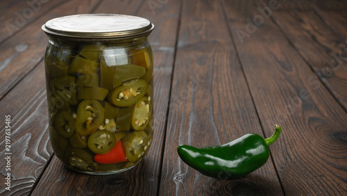 Bild auf Leinwand Fresh and Pickled Jalapenos on Rustic Wooden Table
