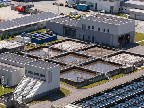Bild auf Leinwand This aerial view shows a wastewater treatment plant with several tanks and treatment areas