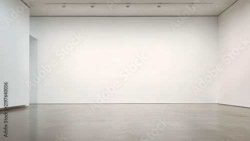 An empty, minimalist art gallery space with white walls and polished concrete floor, awaiting an exhibition or new art installation.
