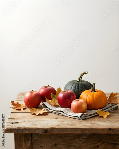 Reduced campaign-ready seasonal scene of seasonal apples, small squash, dried leaves and folded linen, with its physical process or state transition clearly visible for autumn, harvest