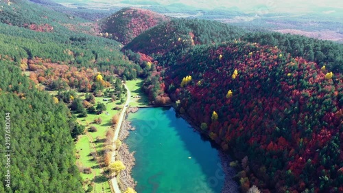 ÅirinyazÄ± Pond in Mengen, Bolu, Turkey surrounded by dense forest and colorful autumn foliage across hills and a rural landscape