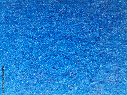 Blue Fibrous Sponge Background. Close-up of a tangled, rough texture. Coarse synthetic fiber. Horizontal shot.