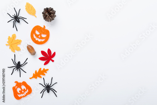 Halloween composition with pumpkins, spiders and leaves on color background, top view