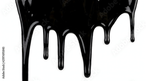 Glossy black viscous liquid dripping slowly with smooth reflective texture