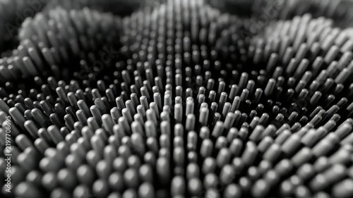Abstract undulating pattern of small cylinders in grayscale