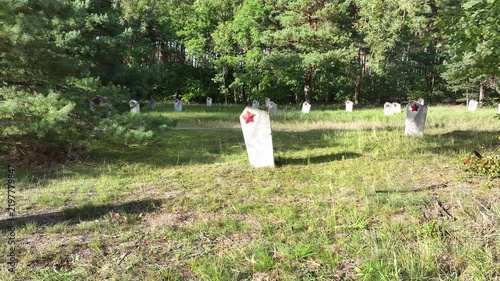 Aerial Torun Poland Soviet soldiers cemetery forest pull climb. Stalag XXI-C was a German Army World War II prisoner of war camp. Memorial is mass graves of over 14,000 prisoners executed. Historical.