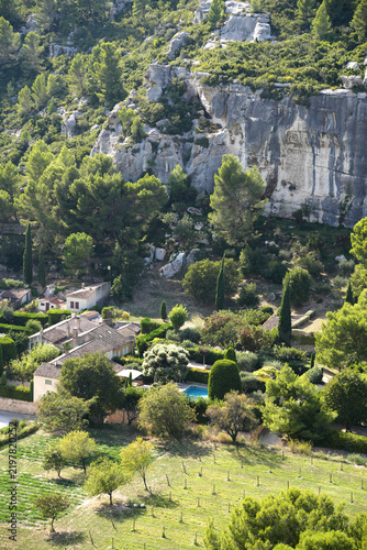Obraz na plátně Pine and broadleaf trees surround a hillside European style house with pool