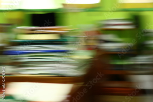 Abstract motion blur of stacked office documents and papers representing busy business workflow