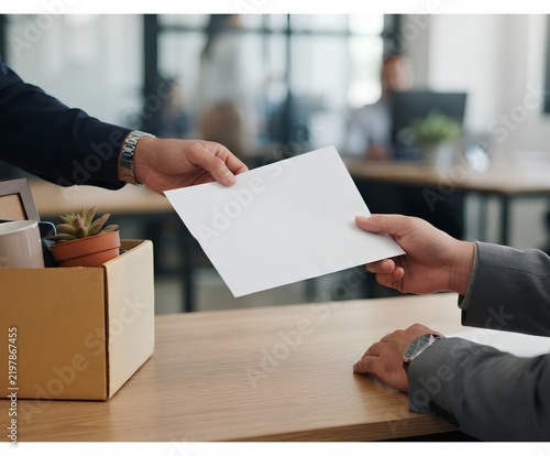 Business person handing a document to a colleague in the office