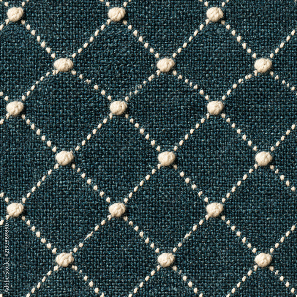 Obraz premium Seamless pattern teal woven fabric creating a background with a quilted diamond pattern. Cream colored knots accent the intersections of stitched lines