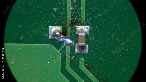 Macro view of a damaged circuit board with a spark while highlighting technology and repair concepts