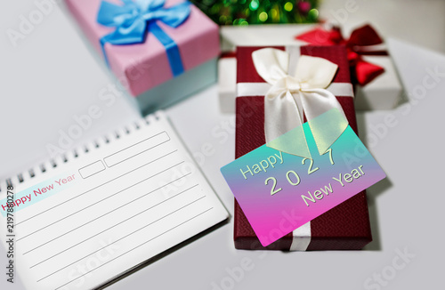 close-up shot, two-tone color of new year card to happy new year 2027 with gift box and christmas background. celebration New Year's Day 2027