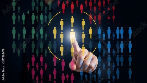 Hand selects glowing person from diverse crowd during digital marketing strategy on dark background