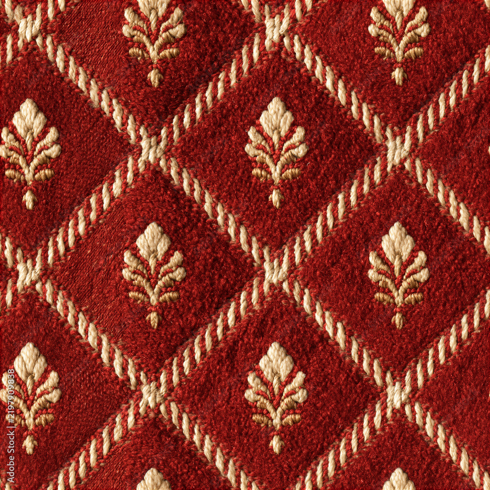 Naklejka premium Seamless pattern red velvet fabric showing elegant gold embroidery within a diamond quilted pattern, creating a luxurious and textured background