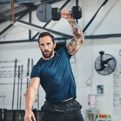 Fotografie Strong, man and workout in gym with dumbbell, weightlifting and functional training for bodybuilder