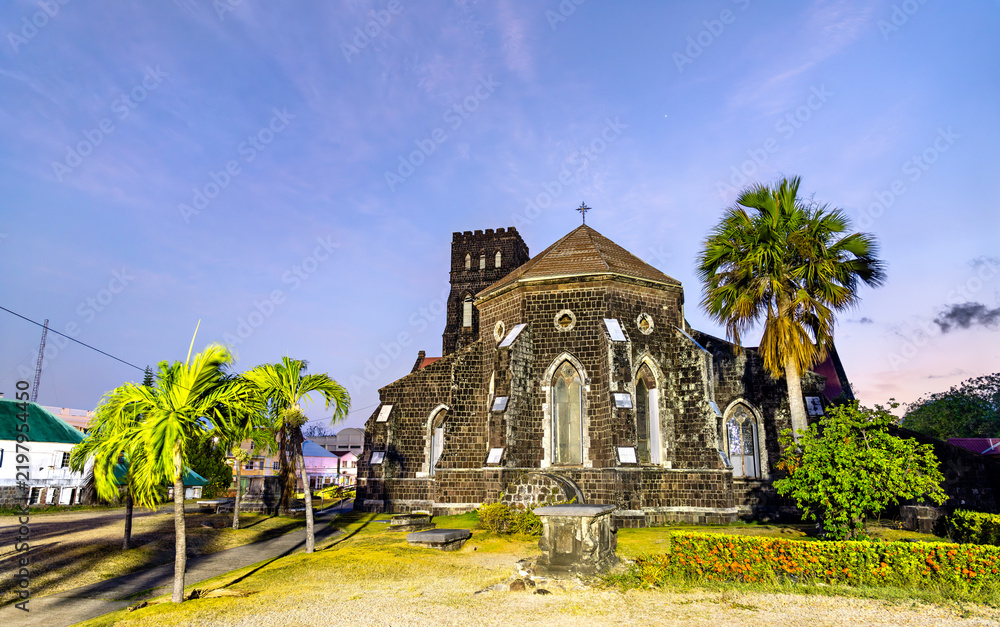 Obraz premium The historic St George's Anglican Church made of volcanic stone under a blue sunset sky in Basseterre, Saint Kitts and Nevis