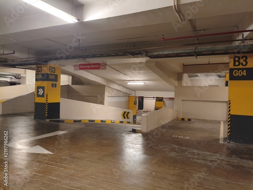 Empty Underground Parking Garage Interior with Ramp and Concrete Structure