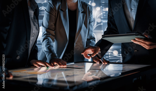 Business Team Collaborating on Interactive Touchscreen Table in Futuristic Office