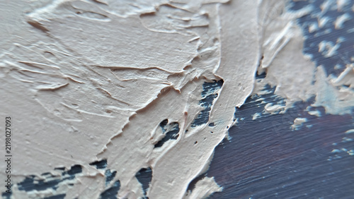 Close up view of thick white and light blue oil paint stroke texture on a canvas background. abstract art texture, creative hobby background, impasto painting technique.