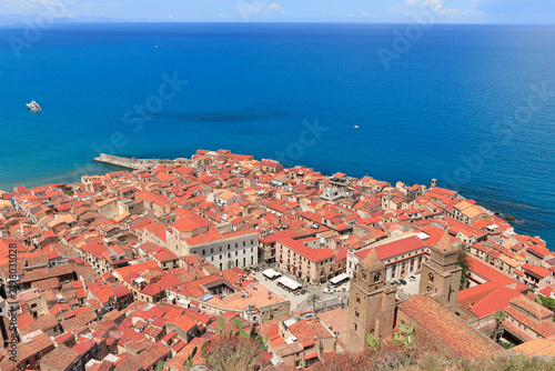 Fotografie Aerial view of a historic coastal town with terracotta roofs and a prominent cat