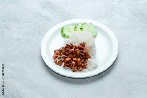 Bild auf Leinwand Savory fried pork chunks served over warm jasmine rice, often accompanied by a spicy dipping sauce or cucumber slices
