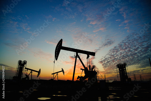 The oil pump, industrial equipment. Oil field site, oil pumps are running.