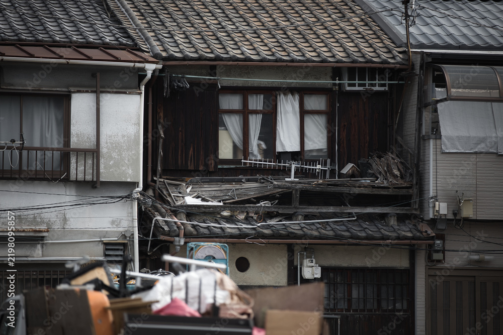 Obraz premium Facade of dilapidated old Japanese row house with clutter, Osaka