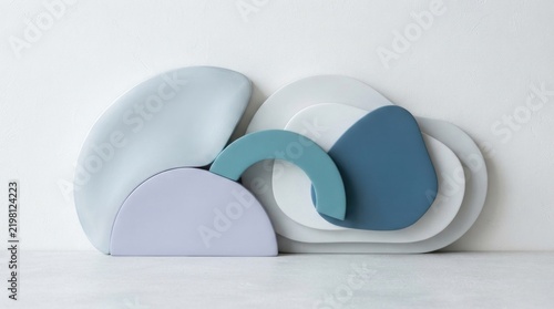 Three abstract geometric shapes in pastel colors, placed on a white background with a soft shadow, creating a minimalist and modern aesthetic.